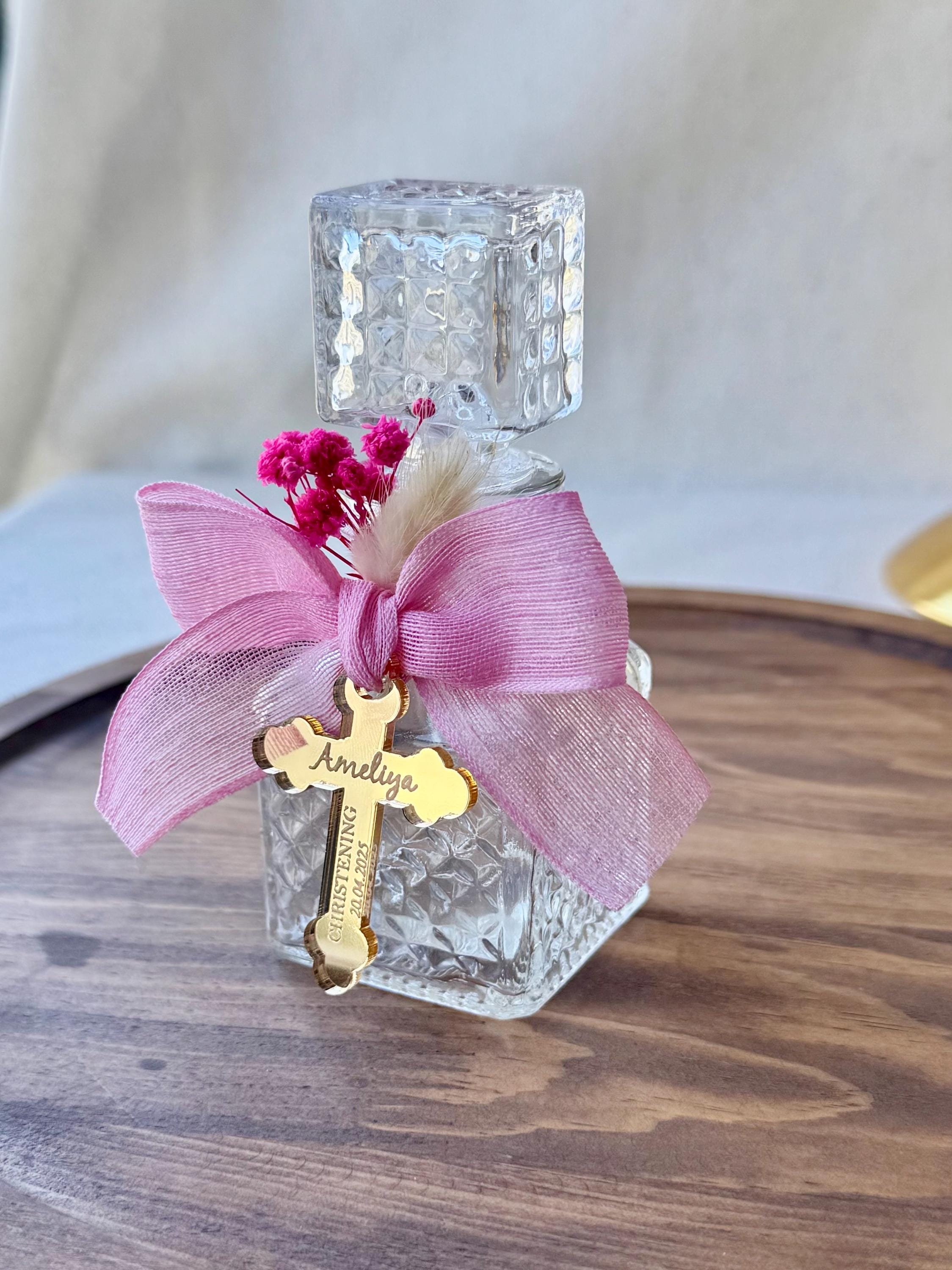 Pink Glass Bottle Religious Favor Custom Charm Design Holy Ceremony Gift Special Occasion Keepsake Dried Flower Decoration Handcrafted Quality Construction Silver Gold Options Available Multiple Charm Choices Beautiful Table Display Sacred