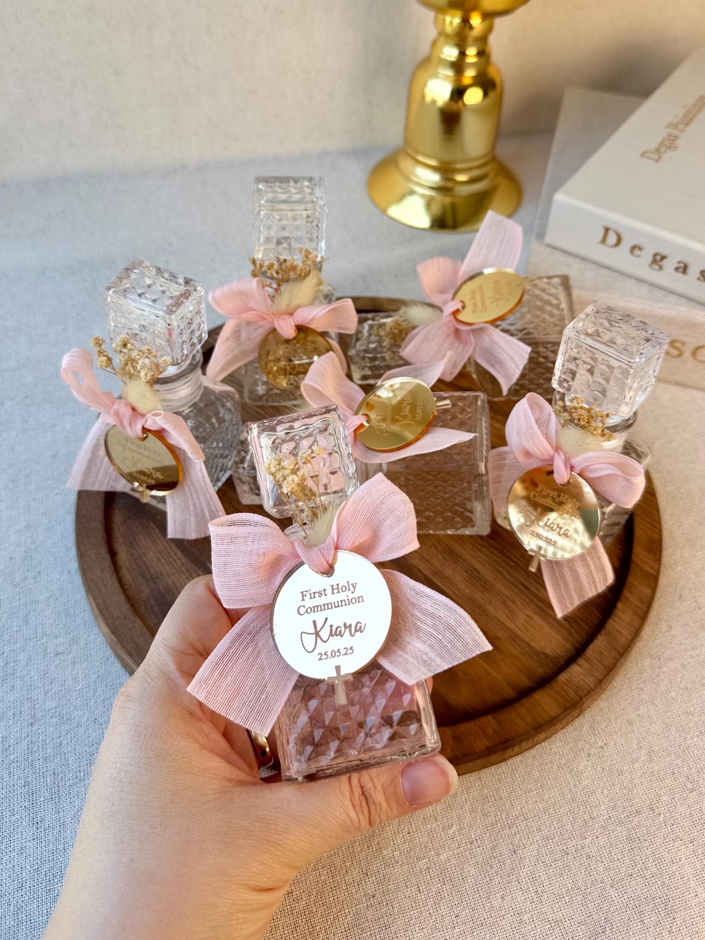 Vintage Glass Baptism Favor Bottle Pink Ribbon Decoration Religious Celebration Keepsake Cross Charm Detail Baby Breath Flowers Special Ceremony Gift Premium Quality Construction Elegant Design Beautiful Presentation Box Traditional Style